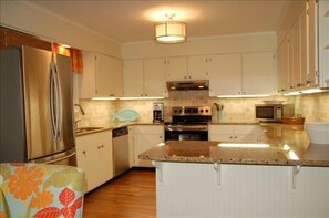 Renovated kitchen with all new stainless appliances and granite countertops.