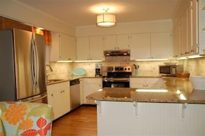 Renovated kitchen with all new stainless appliances and granite countertops.