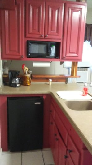 Kitchenette has sink, microwave, coffee pot, mini fridge, and crock pot.
