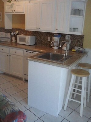 Full kitchen. Newly remodeled w/ brand new appliances. Beach view through patio.