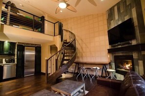 Fireplace with circular staircase to loft