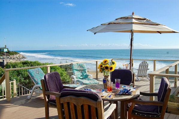 The beach is just a few steps away, but you won't want to leave this huge deck!