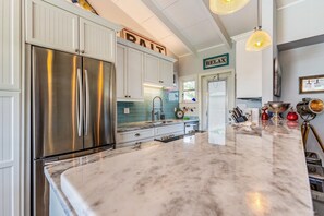 Natural granite counters and blue "sea-glass tile" adorn the kitchen.