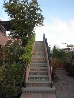 Tiled stairway to 2nd floor terrace, barbecue & lounge area, and master bedroom