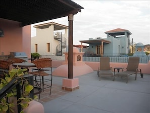 2nd floor terrace with loungers, patio table & chairs, barbecue