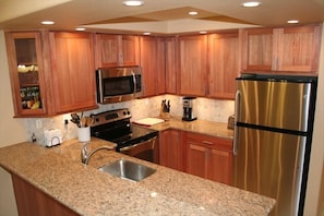 Stainless Appliances, Granite Countertops, Lyptus Wood Cabinets, LED lights.
