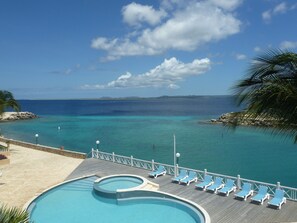 From the balcony.  Morning sun streaming across the pool and seafront.