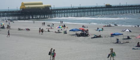 The condo building is the first building after Apache' Fishing Pier