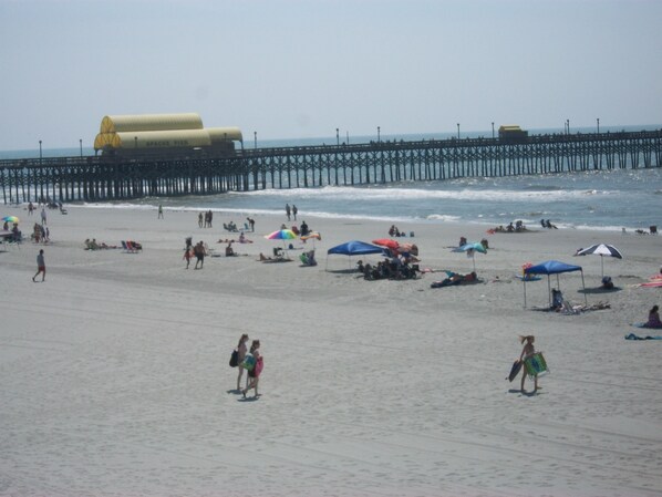 The condo building is the first building after Apache' Fishing Pier