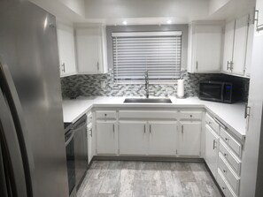 Nicely remodeled kitchen with large stainless steel sink & newer appliances 