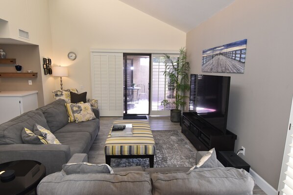 Bright comfortable living Room with 70 inch TV