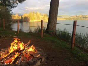 Gather around the fire pit by day or night to enjoy a spectacular lake view.