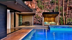 Enjoy the outdoor patio with pool, hot tub, and mountain views for relaxation.