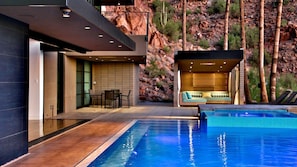 Enjoy the outdoor patio with pool, hot tub, and mountain views for relaxation.