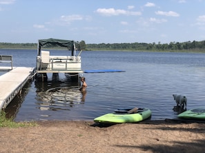 Beach area, pontoon, and paddle boards (blue swim mat not included). 