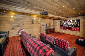 Experience movie night in style! Our luxury home features an 11-seat recliner setup, cozy bean bags, a movie-sized screen, popcorn machine, and candy bar. Perfect for unforgettable family fun!