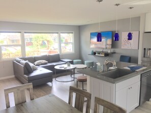 Main living area with large windows which look out to street.