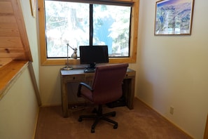 Desk upstairs with monitor, keyboard and mouse