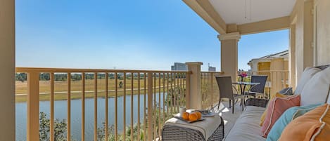 Oversized patio with lake views, plush furnishings, coffee table and a bistro set.  The large, comfy sofa is the perfect spot for a nap