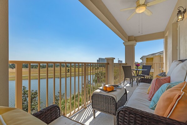 Oversized patio with lake views, plush furnishings, coffee table and a bistro set.  The large, comfy sofa is the perfect spot for a nap