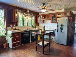 Kitchen with full fridge, oven, , toaster oven, coffee maker