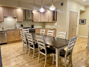 Full Kitchen with Granite Countertops, Dining Table, and High End Appliances 
