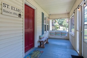 The bright red front door is cheerful and welcoming.