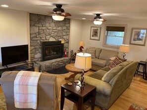 Wood burning fireplace, comfy couch, love seat, and recliner, Smart TV.