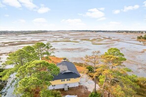 Aerial view of the home on a point.  Home  has one the best views on Tybee.