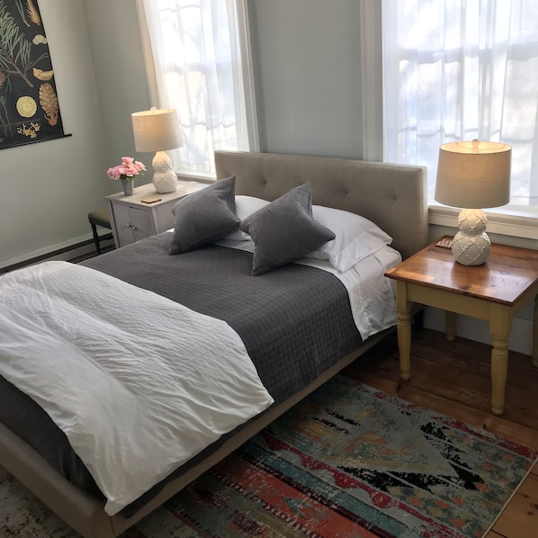 The Suite's main bedroom, with a queen bed and lots of sunshine.