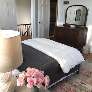 The two doors across the room lead to the hallway and private half bathroom.