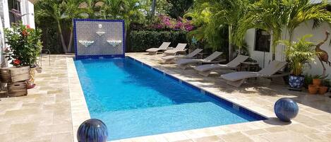 Relax next to the large salt water pool, in a tropical environment, waterfalls