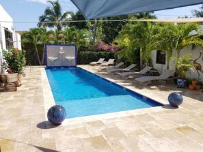 Relax next to the large salt water pool, in a tropical environment, waterfalls