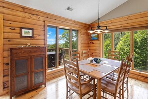 Dining Table with Large Windows which let in Lots of Sunlight, and look out at Mountain Views!