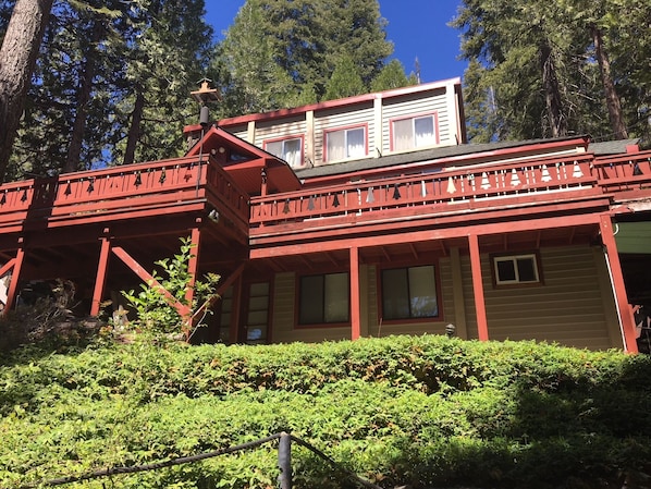 Front View.  Cabin is three levels.  Stone/wooden steps lead up to main entrance