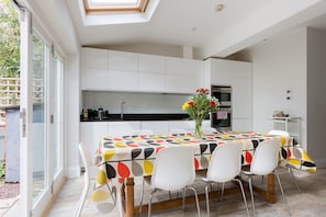 Open plan kitchen/dining space with 
doors to the private patio garden.