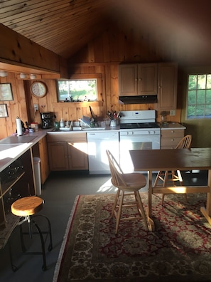 Kitchen with gas range, dish washer, and lunch table.