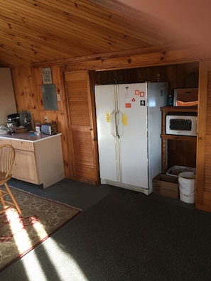 Back will of Roost:  Microwave, Crisper, and side by side Freezer / Fridge.