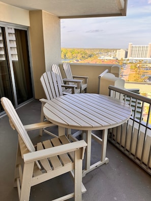 Four high top Adirondack chairs and 4 ft table for your meals with the view