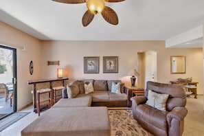 Ceiling fan controlled from remote control on wall.