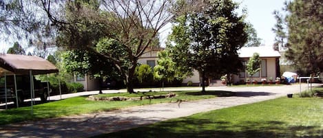 Front yard of property at top of short hill