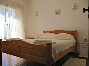 Double bedroom with aircon and leads on to the pool area.