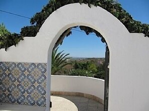 View through archway from pool area.