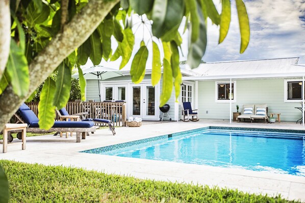 Tranquil pool area within a lush green tropical garden