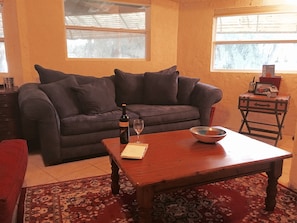 Open concept allows people on the couch to chat with the cook. 
