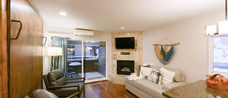 Cozy Living space with Fireplace and HDTV, plus Private Balcony with slope views