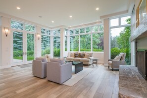 Light filled living room opens onto outdoor patio, gardens and golf course.