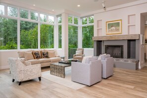 Living room has wood burning fireplace with gas starter.