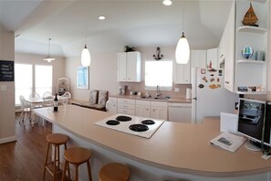 Fully stocked open concept kitchen. Seating for four at bar area.
