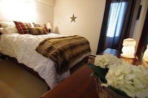 Master bedroom with queen bed, ensuite, closet, and large dresser